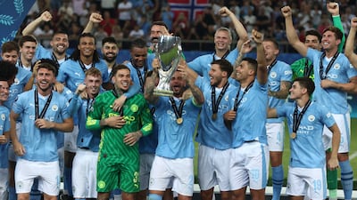 Manchester City players celebrate with the trophy after defeating Sevilla to win the UEFA Super Cup at the Karaiskakis Stadium in Piraeus, Greece, on Wednesday, August 16, 2023. EPA