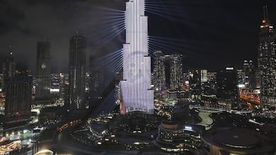 With a projected image of Sheikh Mohammed bin Rashid Al Maktoum, Vice President and Prime Minister of the United Arab Emirates and ruler of Dubai, fireworks explode at the Burj Khalifa, the world's tallest building, to mark New Year in Dubai, United Arab Emirates. AP