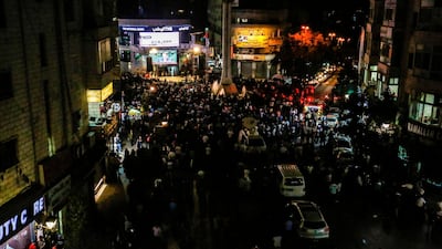 Palestinians watch Palestinian president Mahmoud Abbas on a large screen in the West Bank city of Ramallah. AFP