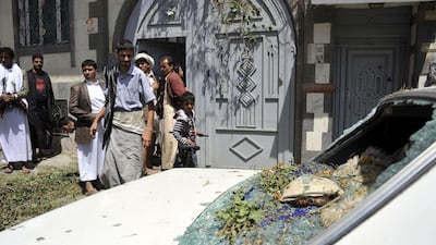 Yemenis inspect the damage from a rocket that landed near a house during clashes between rebels and government forces in the capital, Sanaa, on September 19, 2014. AFP