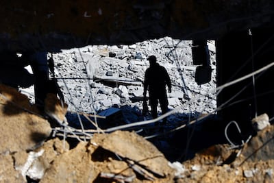 A man surrounded by the debris of what was Sheikh Radwan police station in Gaza city, after an Israeli air strike. AFP