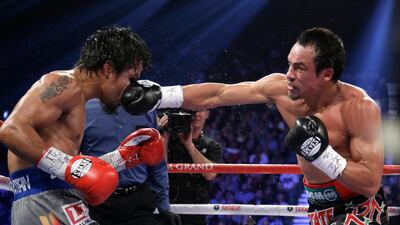Juan Manuel Marquez, from Mexico, right, lands a right to the head of Manny Pacquiao, during their WBO world welterweight fight in Las Vegas. AP Photo / Julie Jacobson