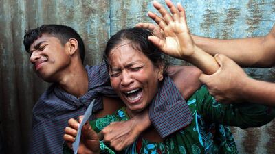 Bangladeshi woman Munni, whose daughters are missing, cries as rescuers search the River Padma after a passenger ferry capsized in Munshiganj district, Bangladesh. A.M. Ahad / AP