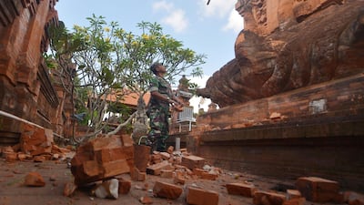 An Indonesian soldier looks at a Hindu temple damaged by an earthquake in Denpasar, Bali, Indonesia. Reuters