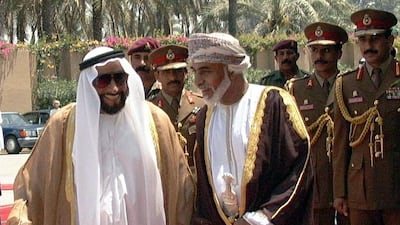 Oman's Sultan Qaboos walks with UAE President Sheikh Zayed in Sohar, Oman, in 1999. Wam / AFP