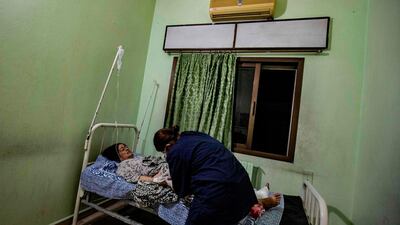 A wounded woman receives treatment at a hospital in the northeastern Syrian Kurdish city of Qamishli, following a Turkish air strike that hit a convoy of vehicles carrying civilians and journalists. AFP