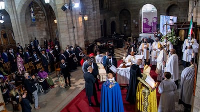 Family members Tutu's coffin during the funeral service. AFP