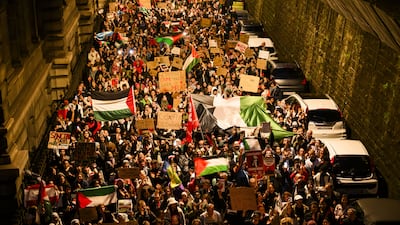 Protesters hold placards and Palestinian flags during a rally in support of Palestinians, in Lausanne, Switzerland. EPA
