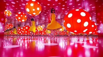 A visitor spins inside the Dot Obsessions installation by Japanese artist Yayoi Kusama at Sharjah Art Foundation in January. Christopher Pike / The National