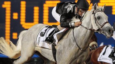 Jockey Royston Ffrench guides AF Lafeh from the outside to win the Mazrat Al Ruwayah, a Group 2 race purebred Arabians, at Meydan Racecourse in Dubai on Thursday night. Jeffrey E Biteng / The National
