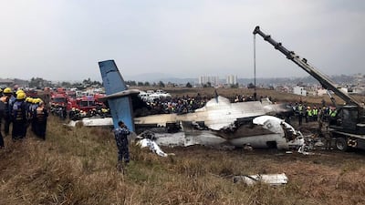Rescue teams next to the wreckage of a plane that crashed at the main airport Tribhuvan International Airport in Kathmandu, Nepal. Narendra Shrestha / EPA