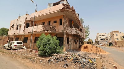 A worker tries to repair a damaged building in Khartoum on September 20, after the return of displaced Sudanese to the capital. AFP