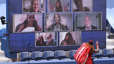 Serena Williams waves to the Jumbotron as she walks off court after winning her US Open quarter-final. AFP