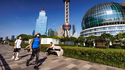 People walk on river bank in Lujiazui, the largest financial zone in mainland China in Shanghai. EPA