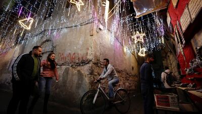 People walk in the Old City of Damascus, which is decorated for the approaching Christmas holidays. AP