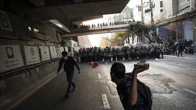 A demonstrator prepares to throw a rock towards riot police during a protest outside the Embassy of Myanmar in Bangkok, Thailand. Andre Malerba/Bloomberg