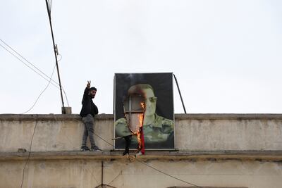 A burning picture of Bashar Al Assad, ousted as president after rebels seized the capital, in Qamishli, Syria. Reuters
