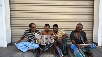 Residents read newspapers near St. Anthony's Shrine in Colombo a day after a series of bomb blasts targeting churches and luxury hotels in Sri Lanka. At least 290 are now known to have died in a series of bomb blasts that tore through churches and luxury hotels in Sri Lanka, in the worst violence to hit the island since its devastating civil war ended a decade ago. AFP