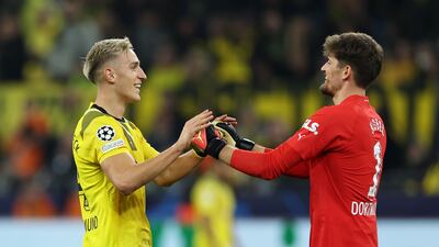 Dortmund's Gregor Kobel celebrates with Nico Schlotterbeck after saving Mahrez's penalty. Getty