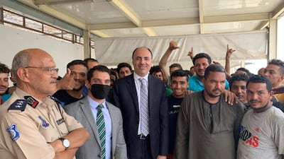 Mohamed Tharwat, the head of the Egyptian diplomatic mission in the Libyan capital, stands with freed Egyptian nationals in Libya. Egyptian Ministry of Foreign Affairs, HO