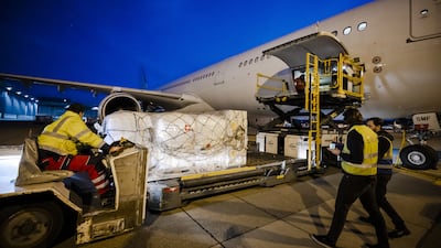 Workers load relief supplies of Swiss Humanitarian Aid for Ukraine population on to an aircraft at Zurich Airport. EPA