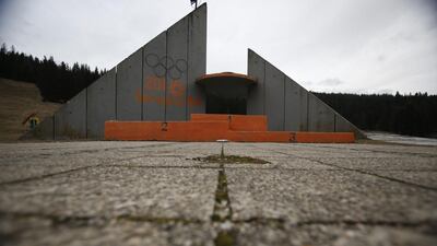 In this picture taken February 21, 2014, a concrete podium for winners with the text “Winter Olympic Games 1984” stands abandoned near jumping hills at Mt. Igman near the Bosnian capital of Sarajevo. Wartime destruction and negligence have turned most of Sarajevo’s 1984 Winter Olympic venues into painful reminders of the city’s golden times. The world came together in the former Yugoslavia in 1984 after the West had boycotted the 1980 Olympics in Moscow and Russia boycotted the 1984 Summer Games in Los Angeles. Just eight years later, the bobsleigh and luge track on Mount Trbevic was turned into an artillery position from which Bosnian Serbs pounded the city for almost four years. Today, the abandoned concrete construction looks like a skeleton littered with graffiti. Amel Emric / AP Photo
