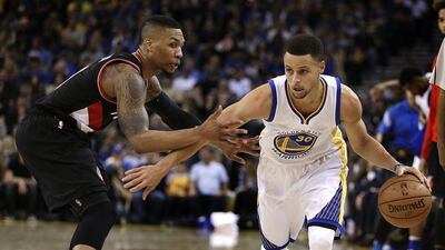 Golden State Warriors' Stephen Curry, right, drives the ball past Portland Trail Blazers' Damian Lillard during the second half of an NBA basketball game Sunday, April 3, 2016, in Oakland, Calif. AP Photo/Ben Margot