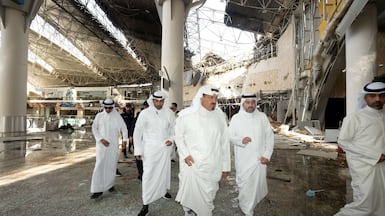 Officials inspect damage inside a terminal at Kuwait International Airport following an aerial attack on the building on June 3. Reuters