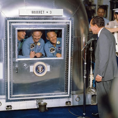 President Richard Nixon speaks to the Apollo 11 astronauts while they quarantined in 1969. (L-R) Neil Armstrong, Michael Collins and Buzz Aldrin. Photo: Nasa