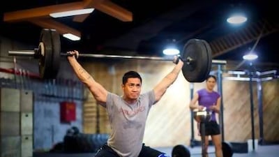 Kim Beso, head coach at the Burn Room, training with weights. Razan Alzayani / The National