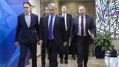 Israeli Prime Minister Benjamin Netanyahu, centre, arrives for a weekly cabinet meeting in Jerusalem on December 25, 2016. Dan Balilty via AP
