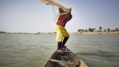A fisherman on his pirogue throws a net in the Niger river in Mopti, Mali. Fishing is threatened by climate changes, unselective fishing and armed groups present in the rural zones in central Mali. AFP