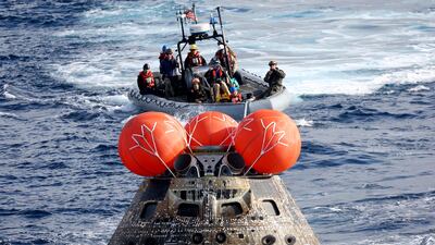Nasa's Orion capsule is retrieved by the USS Portland after it splashed down following a successful uncrewed Moon mission, off the coast of Baja California, Mexico. Reuters