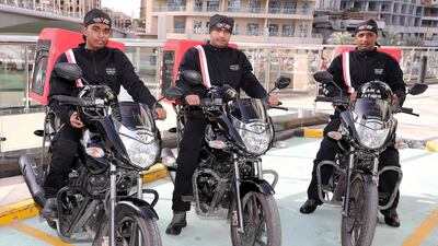 Ranil Suresh, Sajjad Ahmad and Diadarul Haque, delivery riders for Freedom Pizza, at Dubai Marina. Pawan Singh / The National