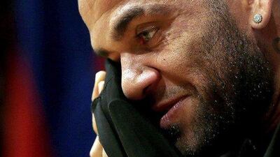 Barcelona's Brazilian defender Dani Alves reacts during a news conference announcing the extension of his contract with Barcelona until 2017, with an option for a third season. EPA/ALBERTO ESTEVEZ