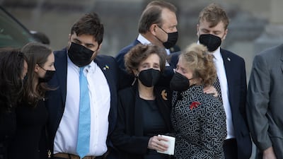 Relatives of Albright comfort one another. EPA