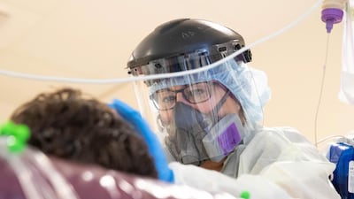 Registered Nurse Monica Escobar, 49, checks on a coronavirus disease (COVID-19) patient, at LAC+USC Medical Center in Los Angeles, California, U.S. Reuters