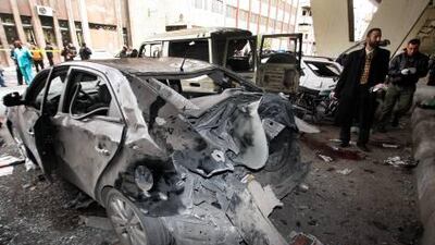 Syrian investigators inspect the scene of a bomb in the Midan neighbourhood of Damascus on Friday.