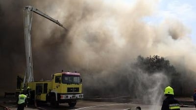 Emergency crews battle the fire which is quickly spreading across Abu Dhabi's Port Zayed.