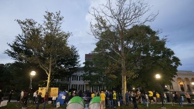 A vigil for victims of sexual abuse, including those assaulted by Nassar, is held across the street from the home of departing University of Michigan President Mark Schlissel in Ann Arbor, Michigan, in October 2021. Getty / AFP