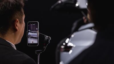 An attendee takes a shot of the freshly unveiled Polestar 3.