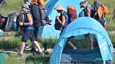 Scouts prepare to leave the campsite. AFP