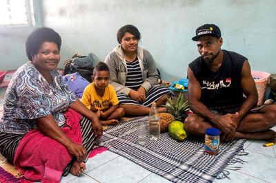 A Fijian family takes refuge in a temporary shelter in the capital city of Suva on December 17, 2020. AFP