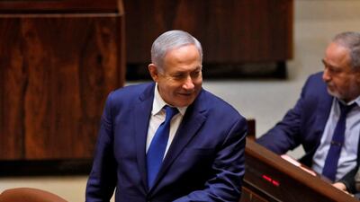 Israeli Prime Minister Benjamin Netanyahu stands next to Israel's former defence minister Avigdor Lieberman during a Knesset (parliament) session. AFP