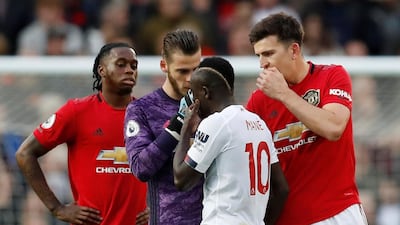 Manchester United's Harry Maguire and David de Gea remonstrate with Liverpool's Sadio Mane, who had a goal ruled out by VAR for handball. EPA