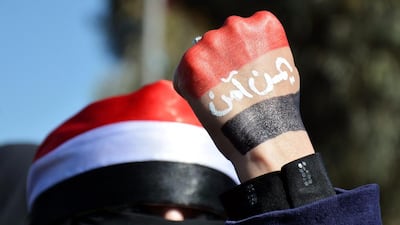 A Yemeni woman has her hand painted in the colors fo the Yemeni flag with the words reading in Arabic ‘Yemen is safe’ during an anti-Houthi protest in Sana'a. (Photo: EPA/WADIA MOHAMMED)