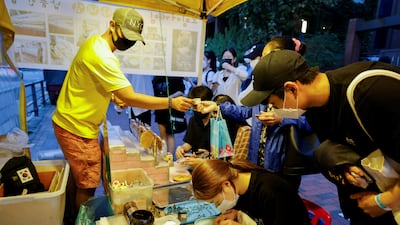 As the show's popularity has surged since its premiere last month, An hasn't been able to go home for a week in order to meet the demand from eager 'Squid Game' fans that start queuing up outside his two-square-metre street kitchen at 11am. Reuters