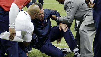 Houston Texans head coach Gary Kubiak, centre, is helped after he collapsed on the field during the second quarter of an NFL football game against the Indianapolis Colts last Sunday. David J. Phillip / AP Photo