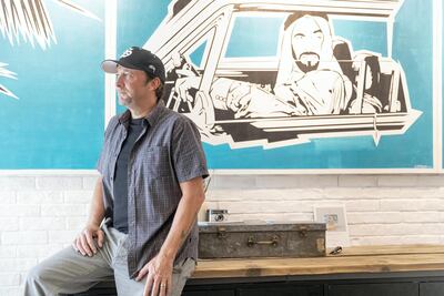 Artist Julian Castaldi with his portrait of Sheikh Zayed at Kulture House. Antonie Robertson / The National