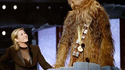 Chewbacca, the eight-foot tall, 200 year-old wookie character from Star Wars, gives his acceptance speech in his own tongue upon receiving the MTV Movie Awards Lifetime Achievement from Carrie Fisher, left, who played Princess Leia Organa in the same movie, June 7, 1997. Reuters